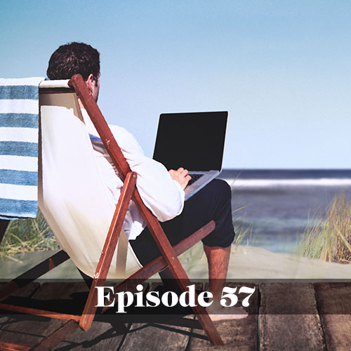 Man working while using a laptop at the beach
