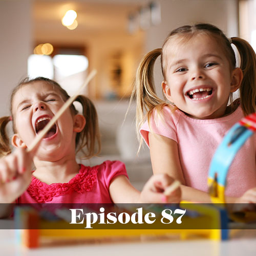 The value of music education in schools, two girls smiling while playing instruments together