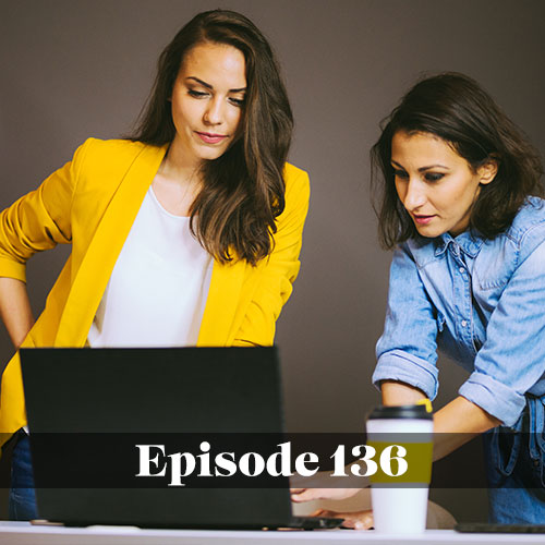 Two women working together with a computer in an office